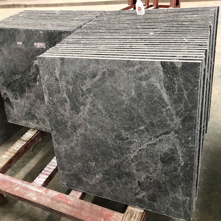 What are the different finishes available for marble tiles, and how do they impact the overall appearance and maintenance of the tiles?